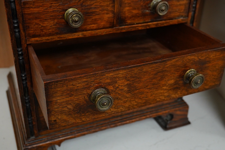 A Victorian oak miniature chest with sliding top, 31.5cm wide, 32cm high. Condition - good